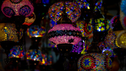 multiple colorful turkish lamps available for sale at a souq.