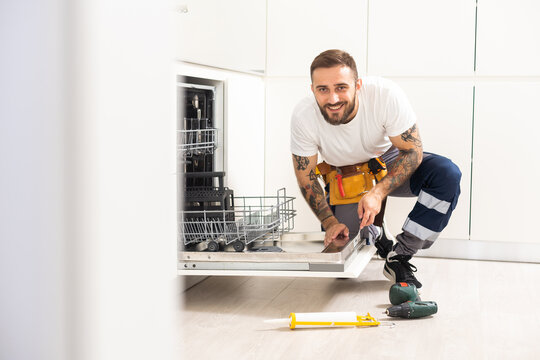 Professional Worker Estimating Cost For Broken Dishwasher