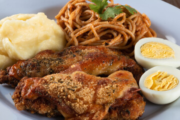 Lunch food plate. Pasta with roasted chicken, mashed and eggs. close up view