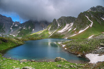 Lake in a mountain valley in cloudy weather.