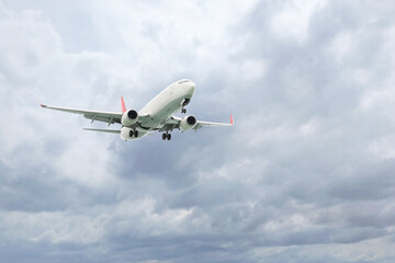 Airplane flying high in cloudy sky. Modern aircraft