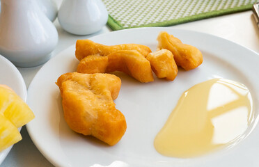 Breakfast with fried dough sticks and sweetened condensed milk.