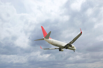 Obraz premium Airplane flying high in cloudy sky. Modern aircraft