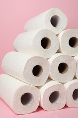 Many rolls of paper towels on pink background