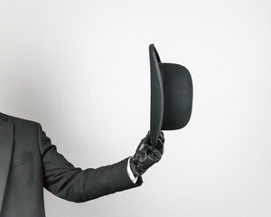 Isolated Image of Arm Holding Bowler Hat. Concept of Classic British Butler or English Gentleman.
