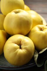 Fresh ripe organic quinces on plate, closeup