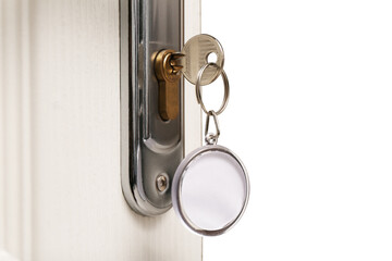 Key with fob in door lock, closeup. Space for text