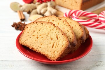 Slices of delicious gingerbread cake on white wooden table, closeup