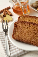 Fresh gingerbread cake slices served on white wooden table, closeup