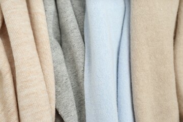 Fototapeta na wymiar Different cashmere clothes as background, closeup view