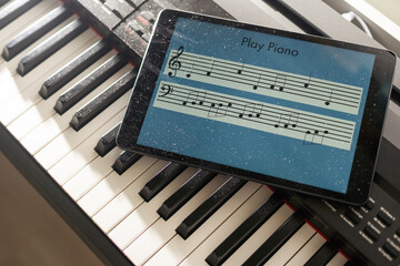 piano with video lessons. Concept of virtual learning