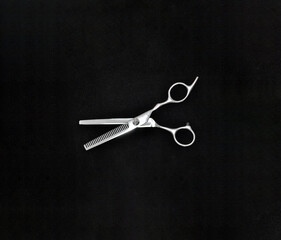 hairdressing scissors isolated on black background