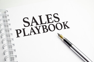 sales playbook words with pen and paper