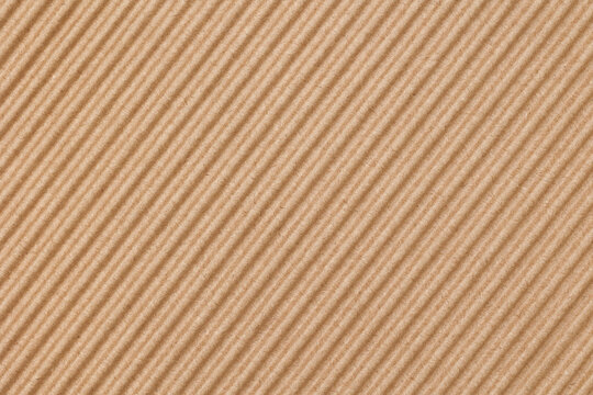 Top view of a corrugated cardboard sheet, brown color, the sheet is orientated diagonally