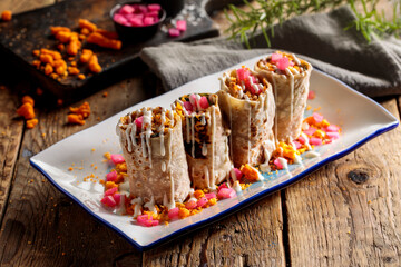 Assorted chicken saj, shawarma, doner wraps served in tray isolated on cutting board side view on table fastfood