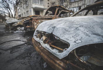 Completely burnt vehicles cars after shelling by rocket artillery in a residential area in Ukraine during the military escalation of hostilities and armed military aggression