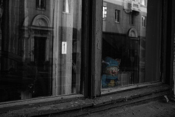 an old toy watching the autumn city with interest