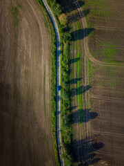 Aerial photo of a dirt road with a blue car