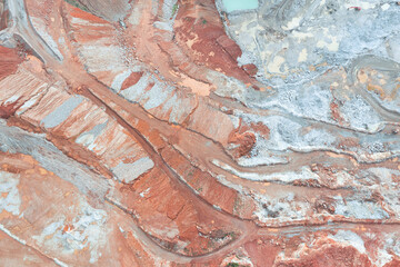Aerial view of the quarry, beautiful orange patterns and overhanging rocks in a copper-magnesium...