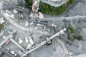Aerial view of crushing equipment, stone crusher in a quarry, mining equipment for processing and sorting stone, crushed stone, flour - obrazy, fototapety, plakaty