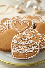 Tasty heart shaped gingerbread cookies in plate, closeup