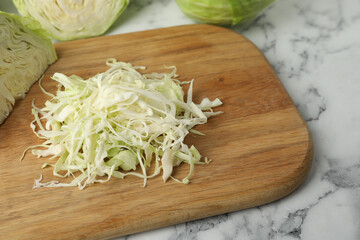 Chopped ripe cabbage on white marble table, closeup