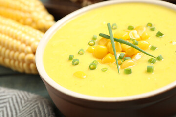 Delicious creamy corn soup on table, closeup