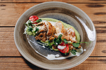 There are a lot of slices of some meat with cream in the plate in the restaurant.
