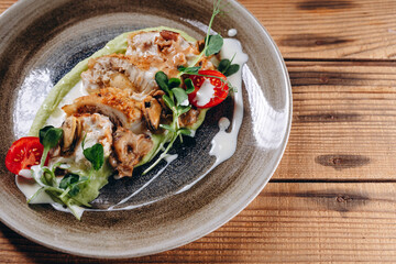 There is some meat with cream in the plate in the traditional restaurant.