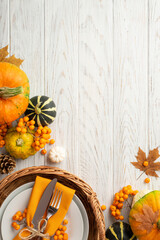 Thanksgiving day concept. Top view vertical photo of rattan basket with plate knife fork napkin...