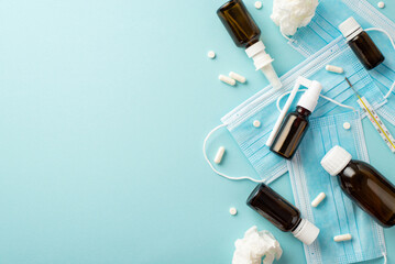 Illness concept. Top view photo of medicines syrup and spray bottles face masks pills capsules...
