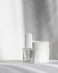 A set of manicure tools and accessories on a white background. Nail polish and cotton pads