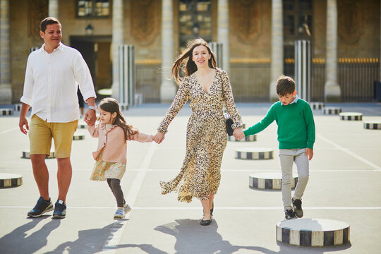 Happy family of four enjoying their trip to Paris, France