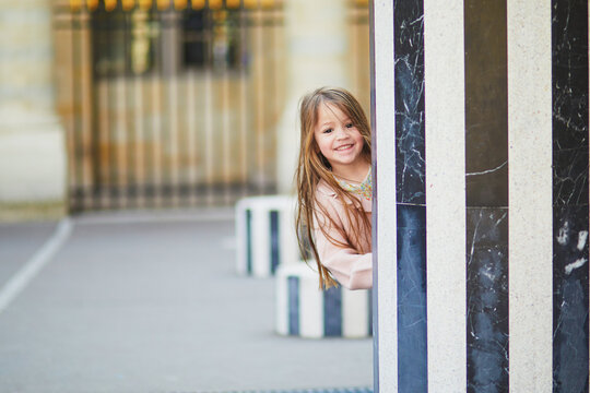 Girl running in Palais Royal garden
