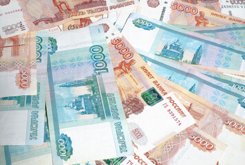horizontal background of paper money spread out in a fan in denominations of one thousand and five thousand Russian rubles