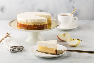 Apple cheesecake on cake stand and cup of tea. White background. - obrazy, fototapety, plakaty