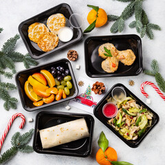 Restaurant healthy food delivery in take away boxes for daily nutrition on white stone background, christmas background