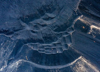 texture of black and purple lacquer with metallic inclusions, mountains of industrial waste,...