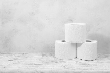 Toilet paper rolls on a gray concrete background, used as a hygiene product in washrooms, a scarce commodity in the energy crisis in Europe