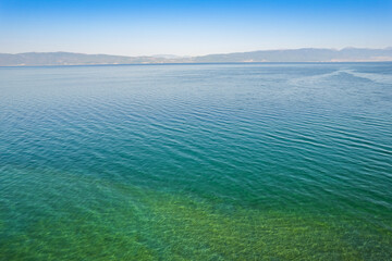 Different colors of blue in Ohrid lake in Summer of bird view