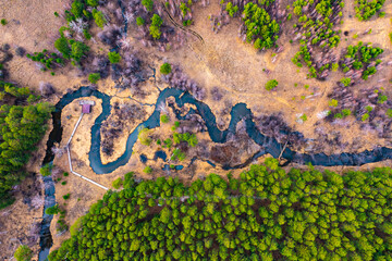 Aerial top down view plain river Psel during spring time. Beautiful valley of riverbed with green...