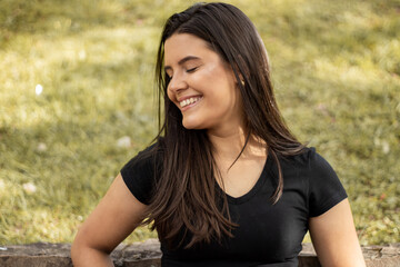 Smiling young girl posing in a park