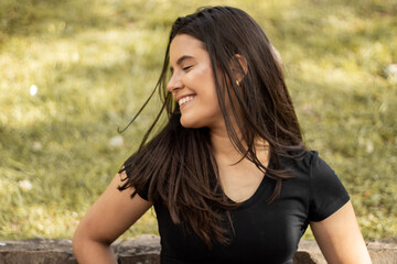 Smiling young girl posing in a park