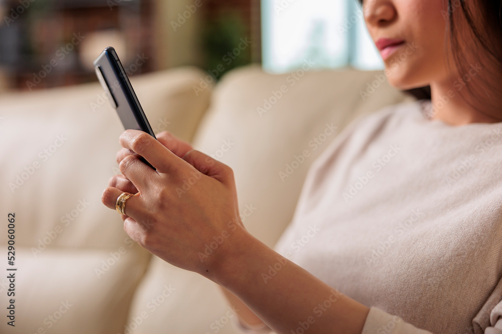 Poster casual authentic looking happy asian woman using smartphone at home, web internet technology smartph