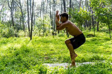 man seen up close, without shirt doing stretches on yoga mat, exercise, latin america
