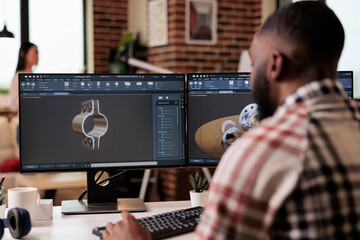 African american developer setting up gears model on manufacturing software, developing engine...