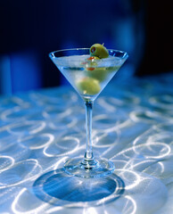 Green olives in a martini glass