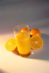 Glass of orange juice and oranges