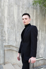 Vertical portrait of stylish hipster young man posing outdoor. mock-up. 