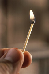 Person holding a burning matchstick